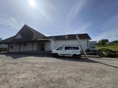 CGS Roofing van and ladder outside the clubhouse at Moffat Golf Club during roof repairs